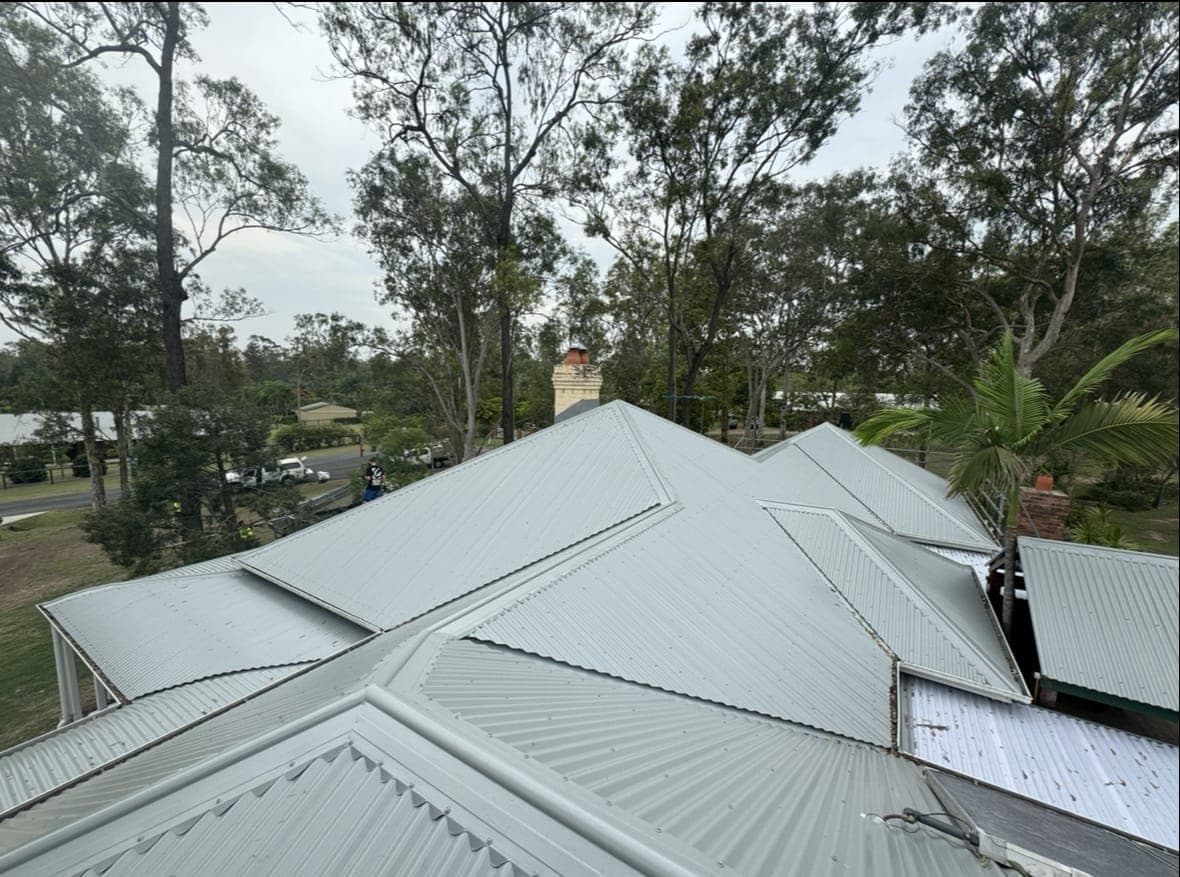 Light grey Colorbond roof surrounded by gum trees